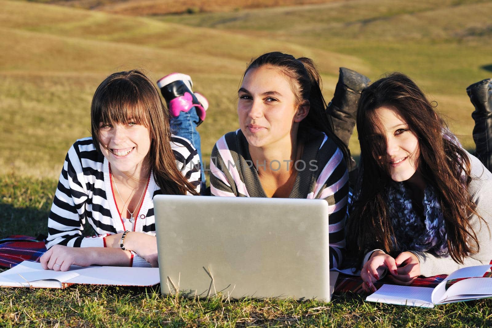 group of teen girl woman outdoor have fun and study homework on laptop computer