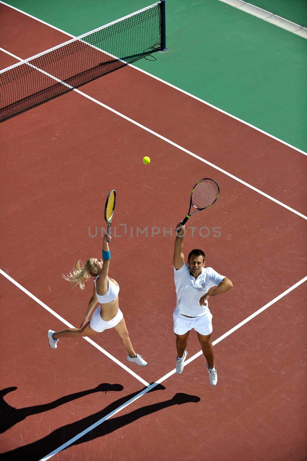 happy young couple play tennis game outdoor man and woman