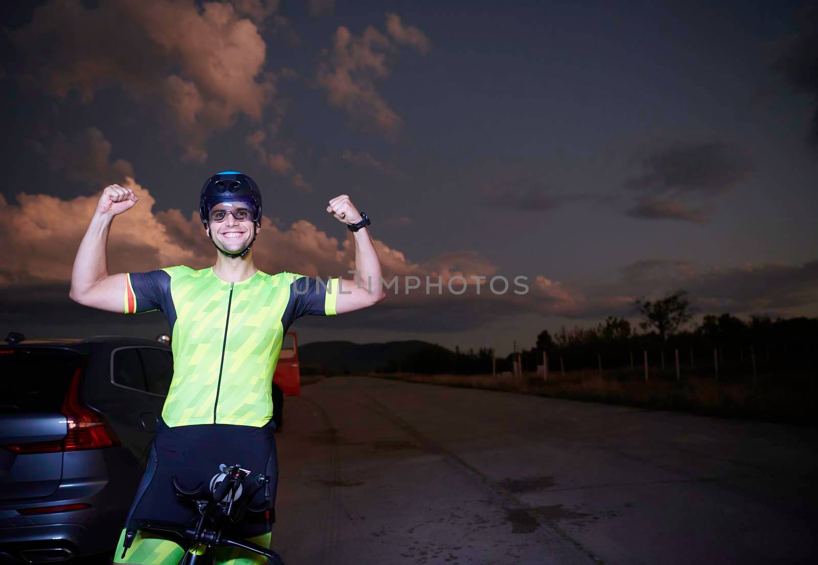 triathlon athlete portrait while resting on bike training by dotshock