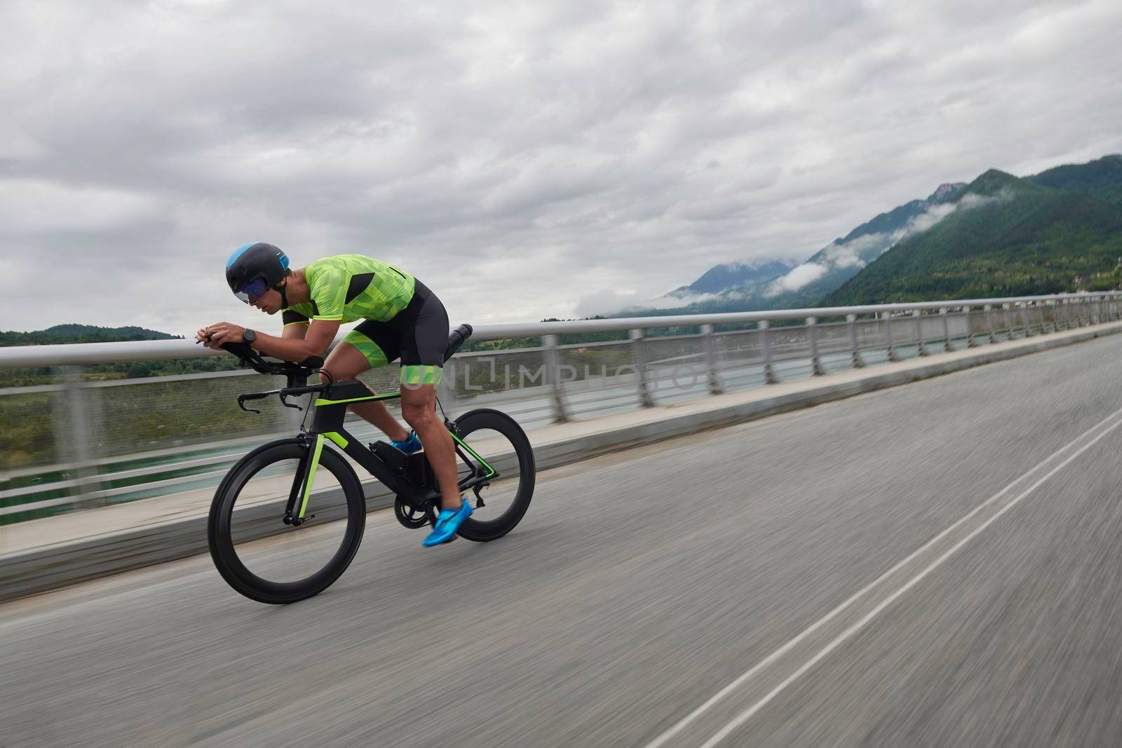 triathlon athlete riding racing bike on morning training urban enviroment