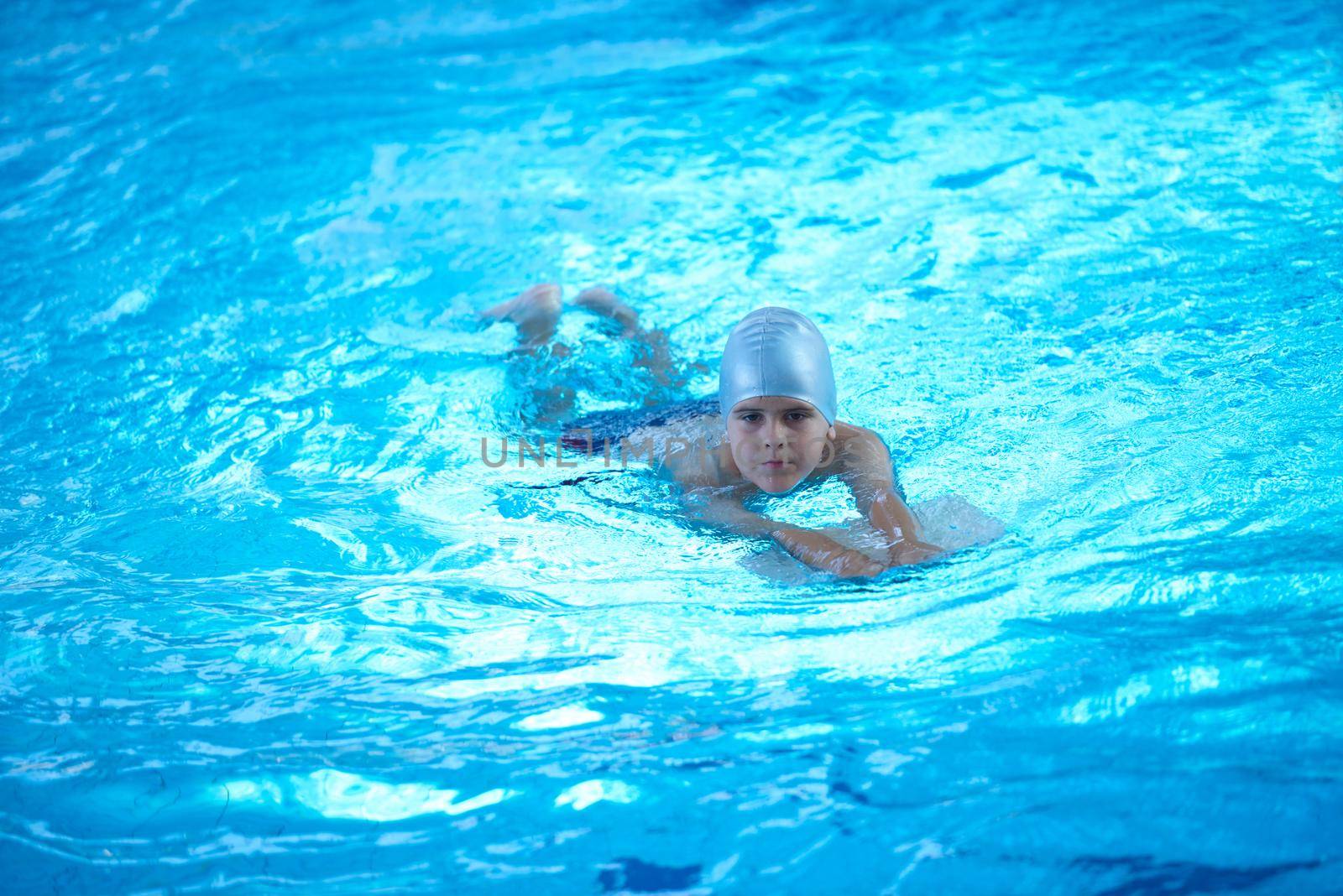 child on swimming pool learning to swim w