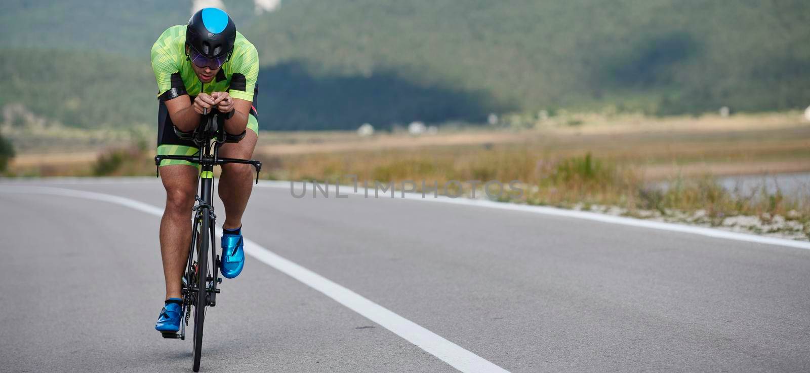 triathlon athlete riding bike by dotshock