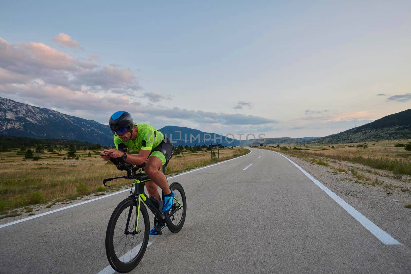 triathlon athlete riding bike by dotshock