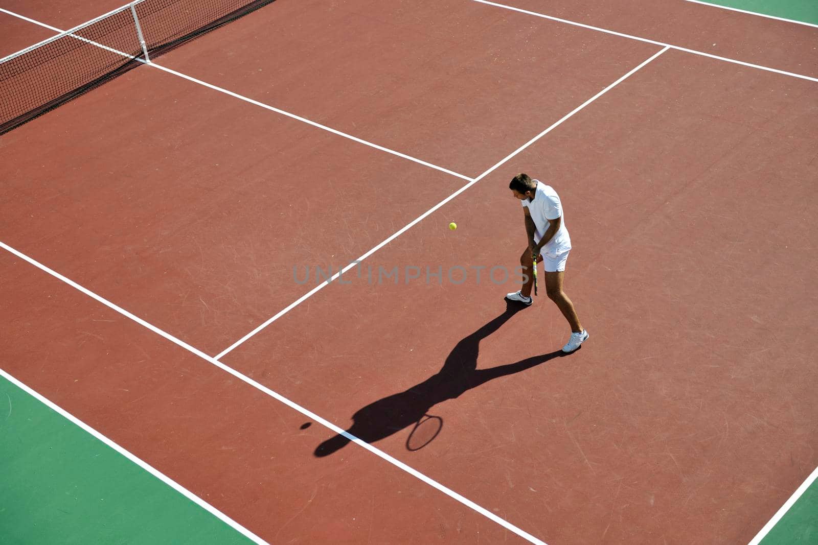 young man play tennis by dotshock