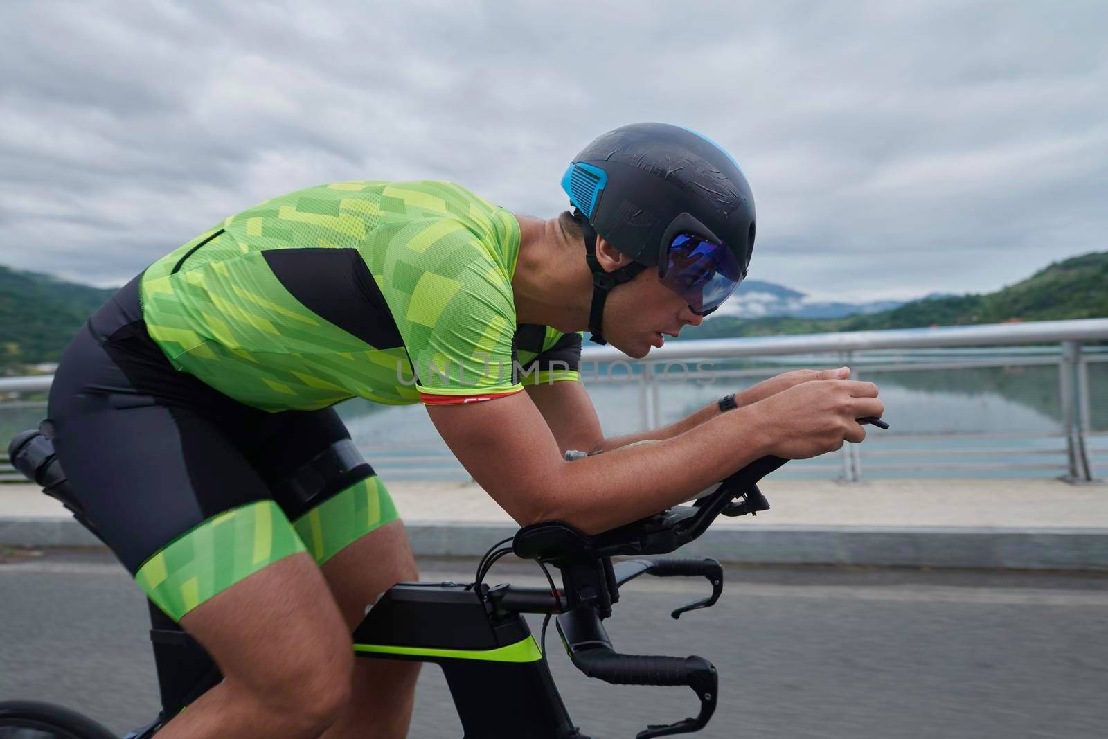 triathlon athlete riding a bike on morning training by dotshock