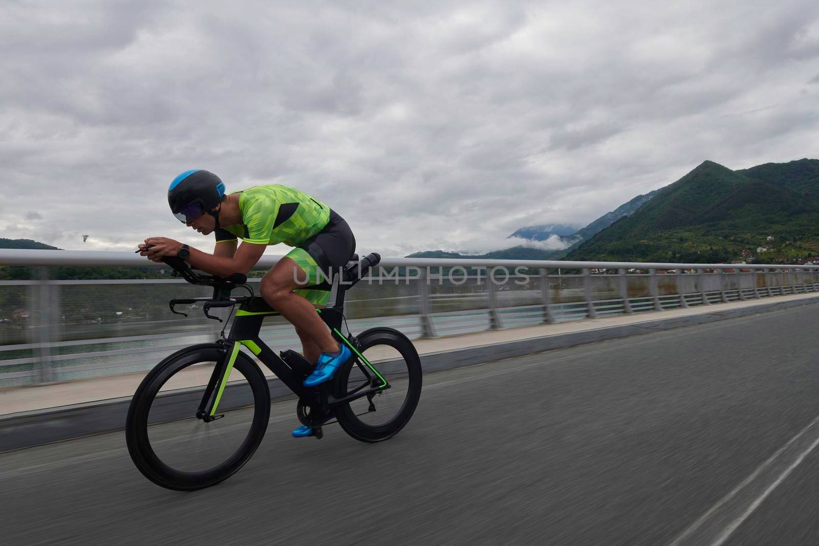 triathlon athlete riding a bike on morning training by dotshock