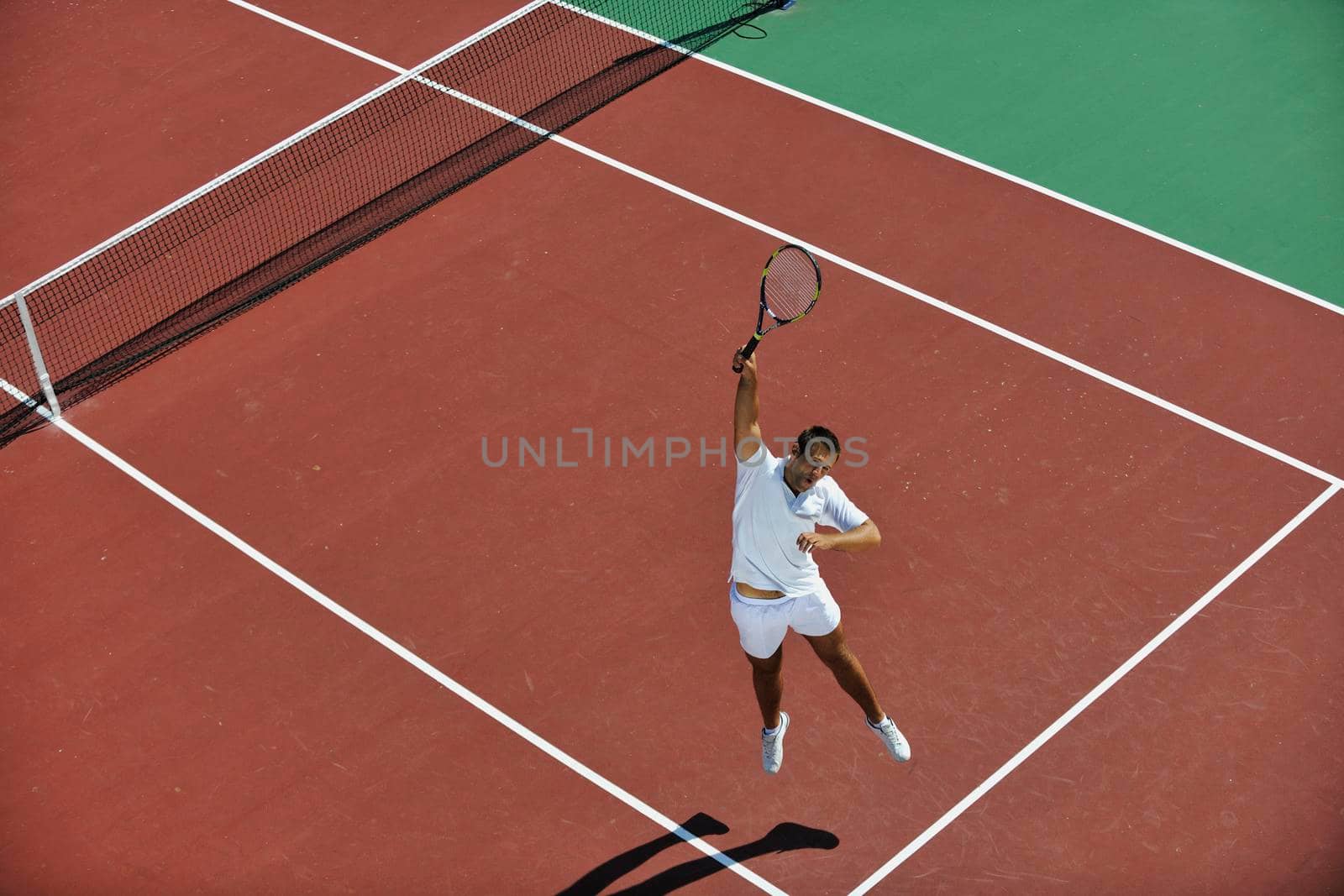 young man play tennis by dotshock