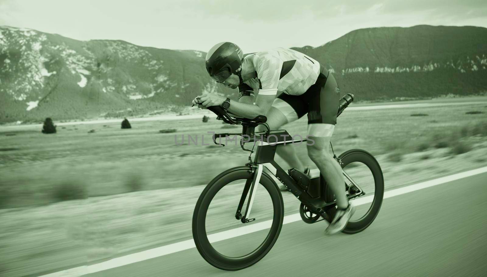 triathlon athlete riding bike by dotshock