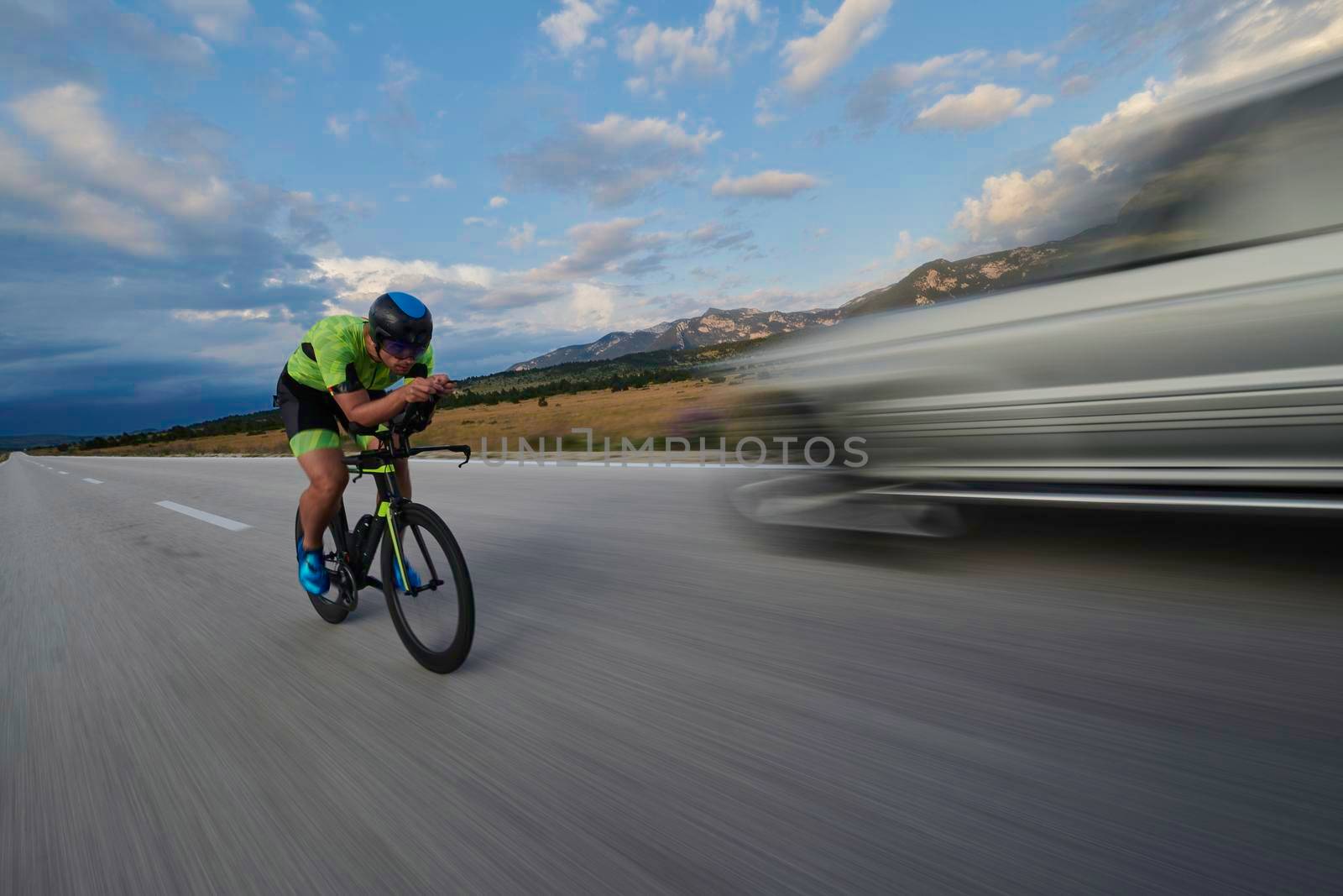 triathlon athlete riding bike by dotshock