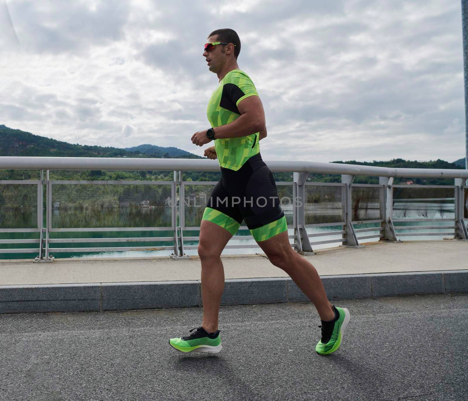 triathlon athlete running on street urban enviroment morning training workout