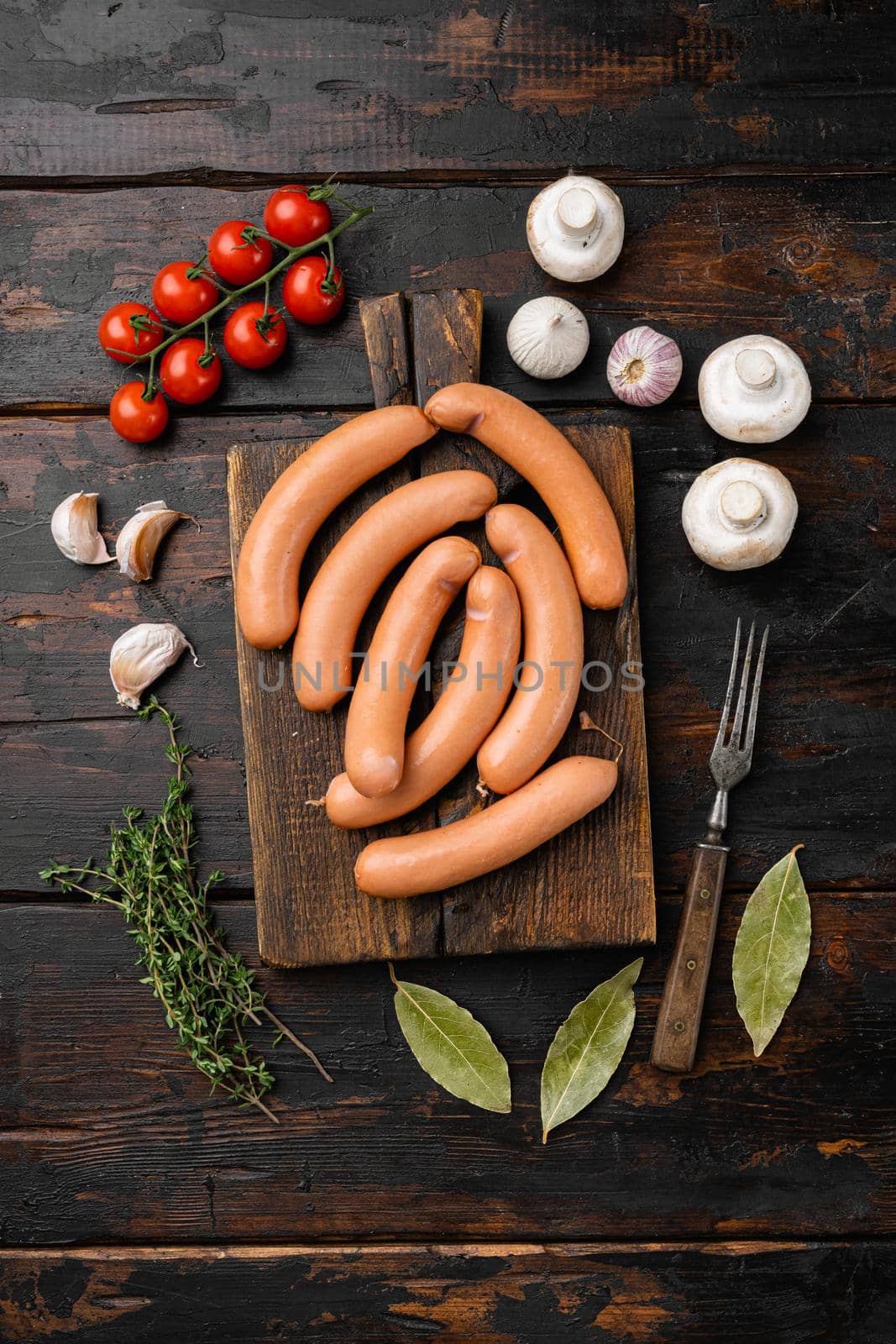 Raw pork and beef mix sausage set, on old dark wooden table background, top view flat lay