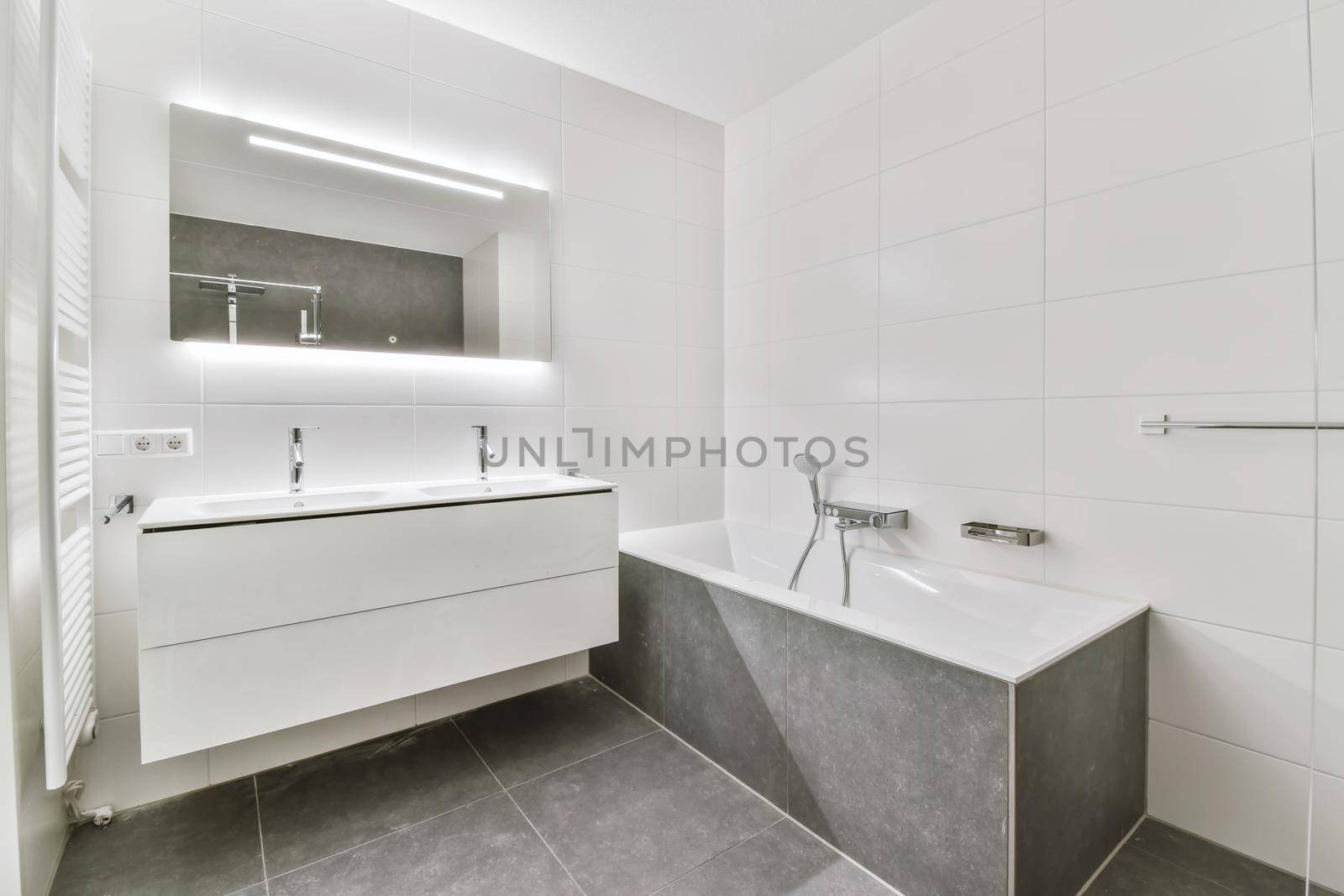 Modern bathroom with gray tiled floor by casamedia