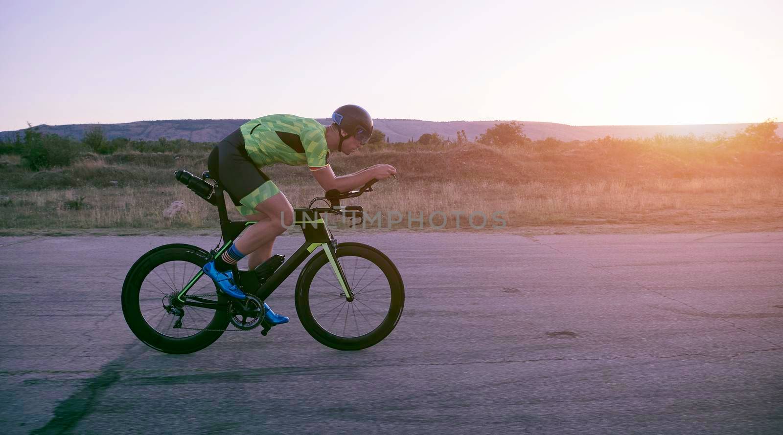 triathlon athlete riding a  bike by dotshock