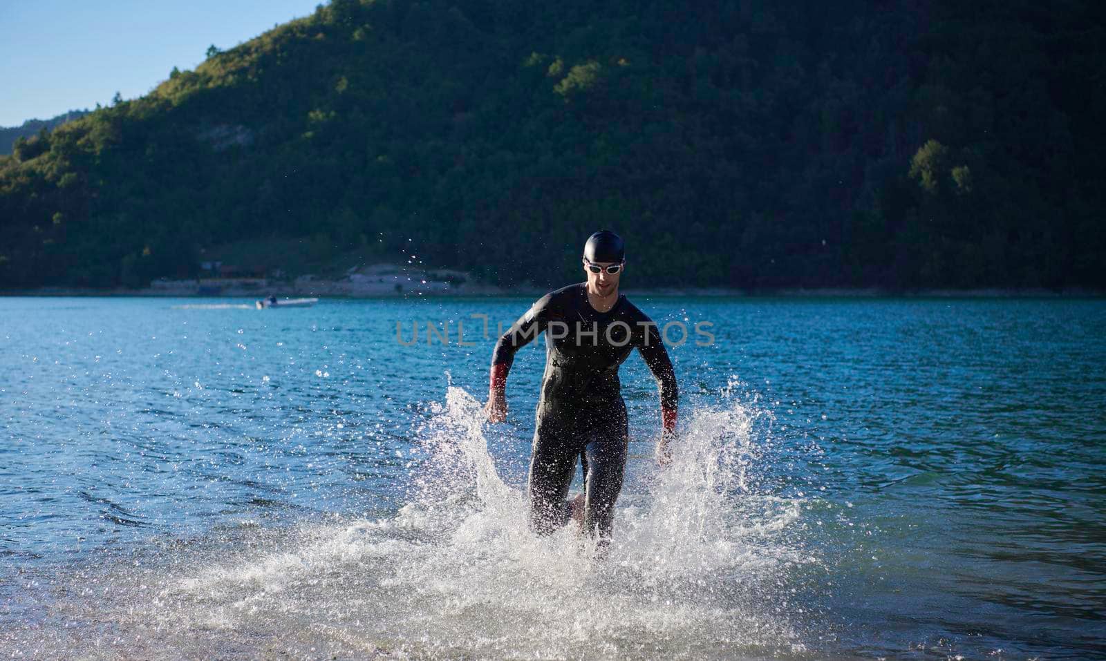 triathlon athlete start swimming training splashing water while running and jumping