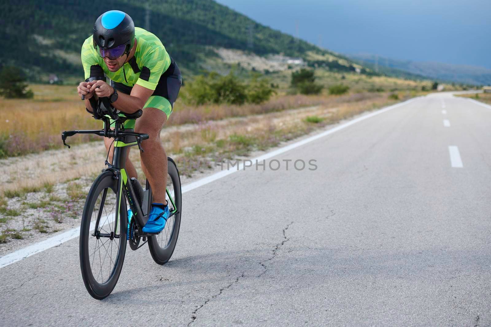 triathlon athlete riding bike by dotshock
