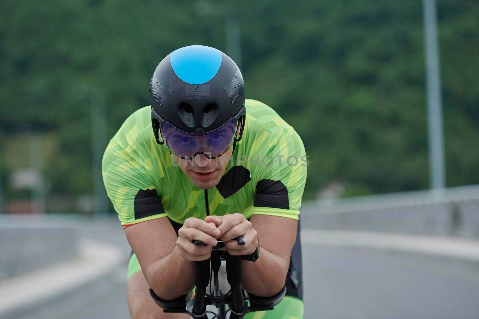 triathlon athlete riding racing bike on morning training urban enviroment