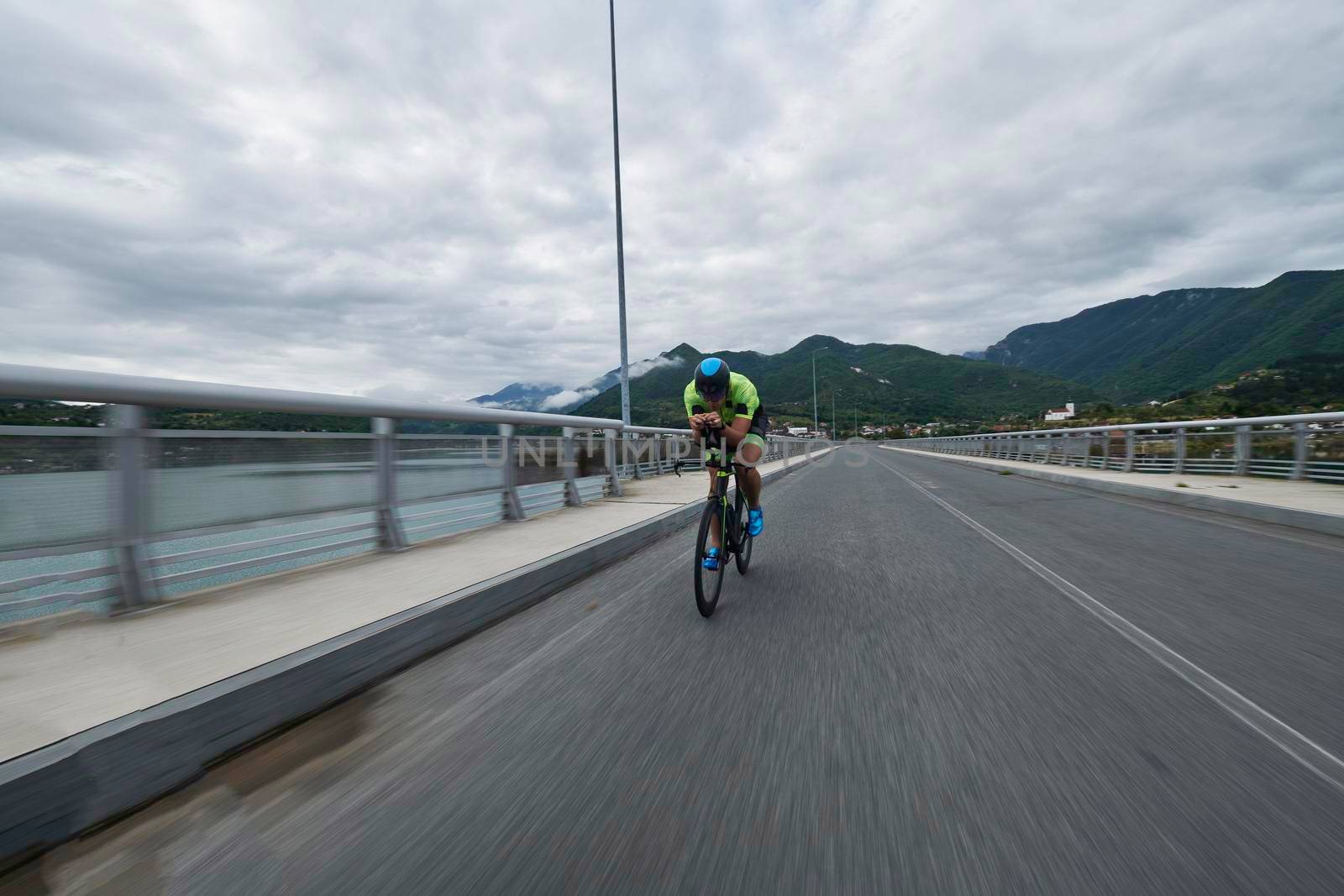 triathlon athlete riding racing bike on morning training urban enviroment