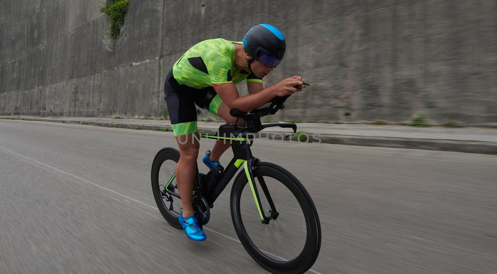 triathlon athlete riding a bike on morning training by dotshock