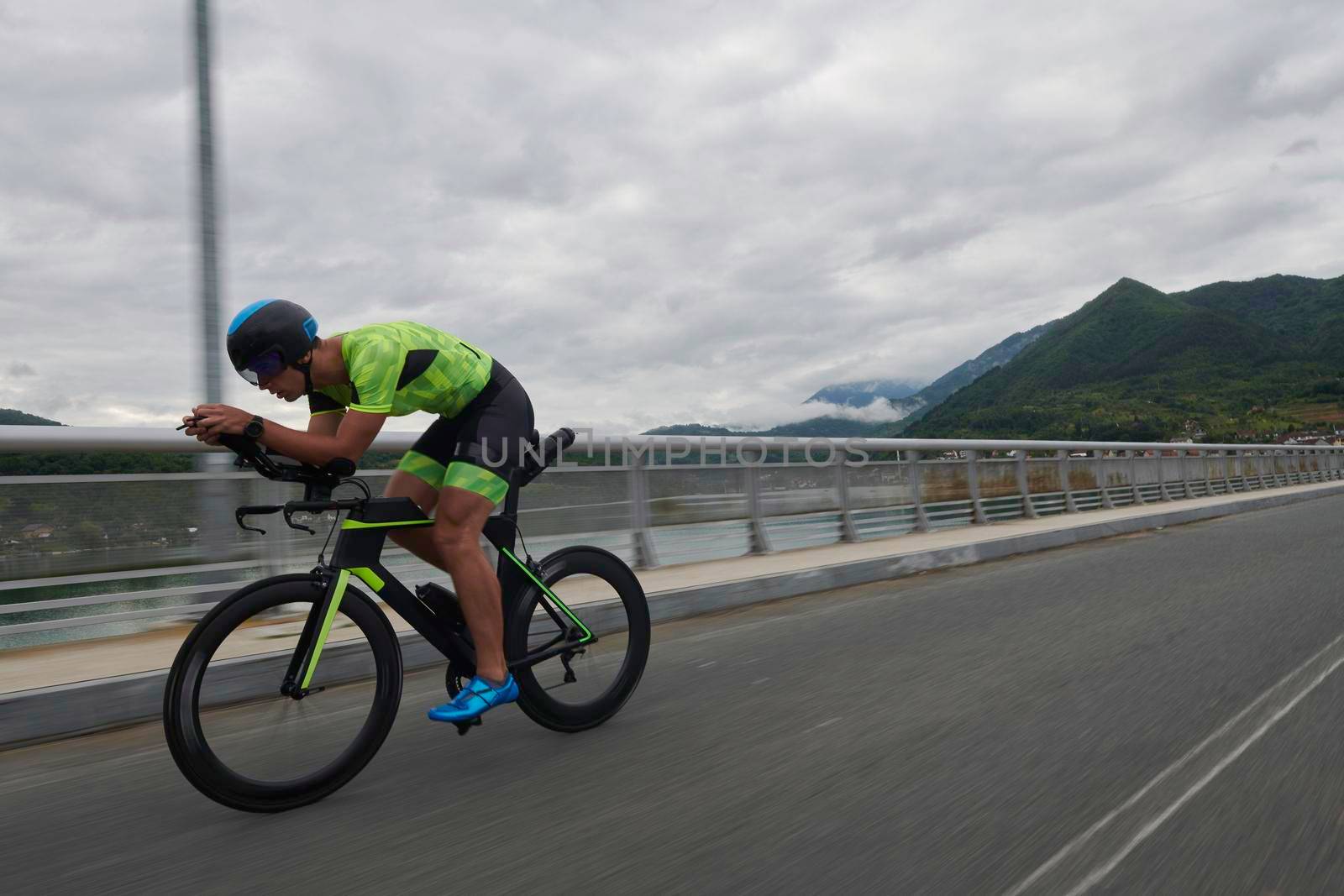 triathlon athlete riding racing bike on morning training urban enviroment