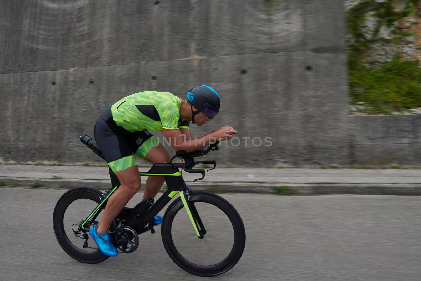 triathlon athlete riding racing bike on morning training urban enviroment