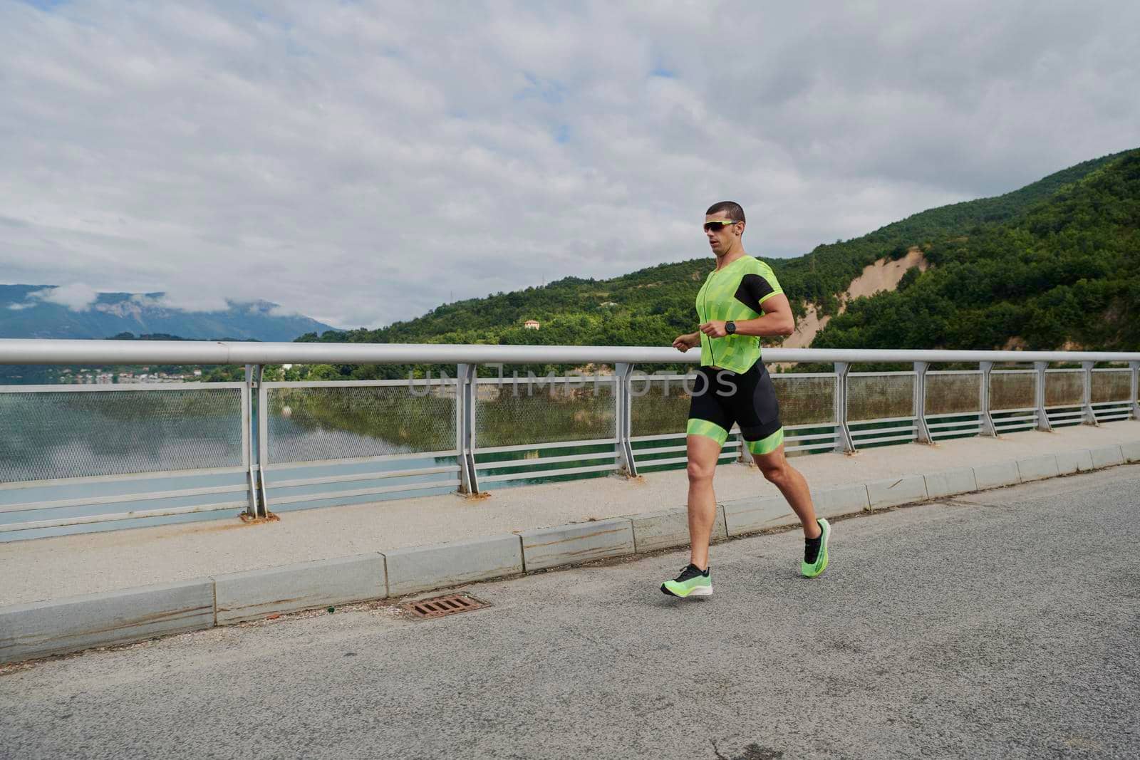 triathlon athlete running on street urban enviroment morning training workout