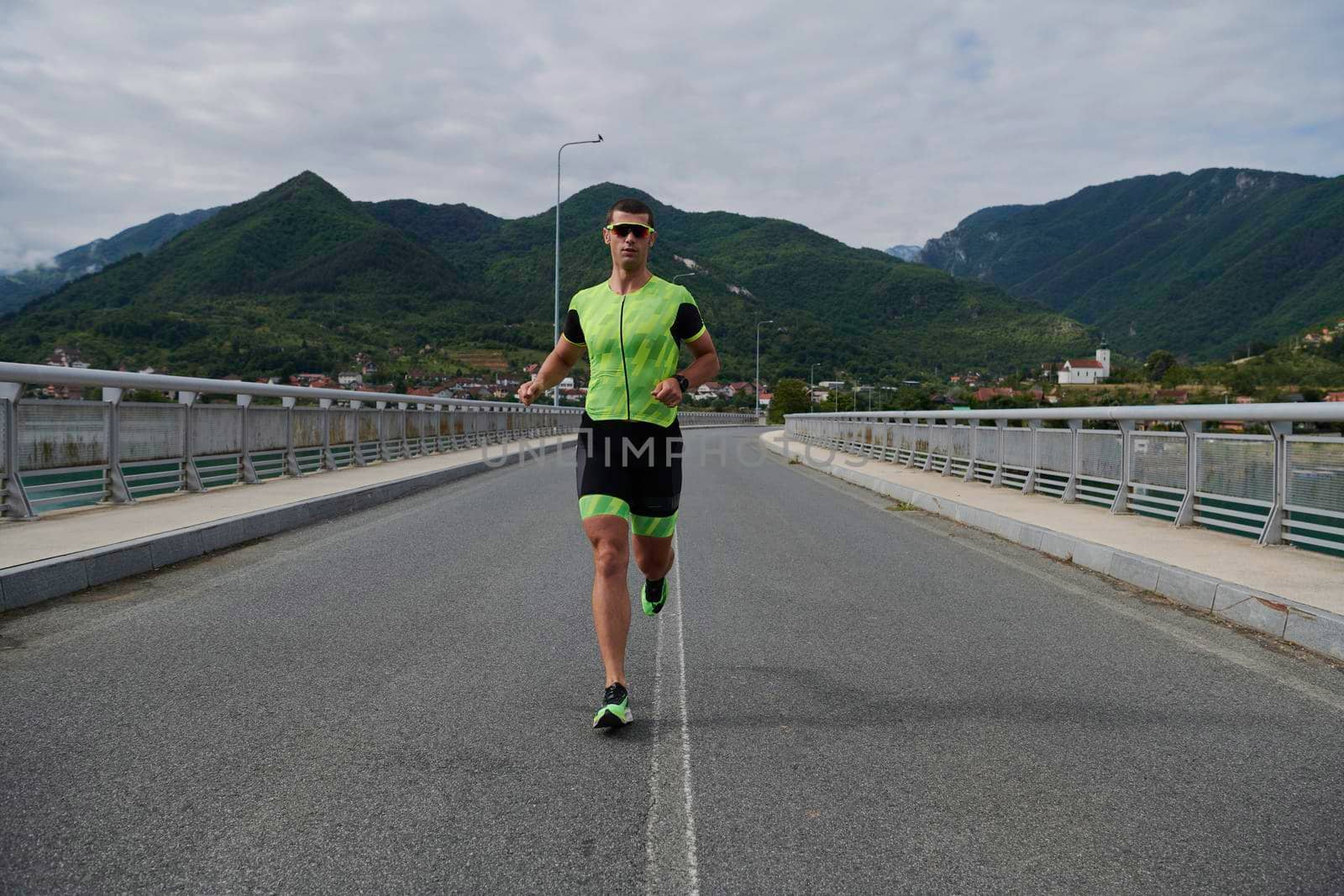 triathlon athlete running on street urban enviroment morning training workout