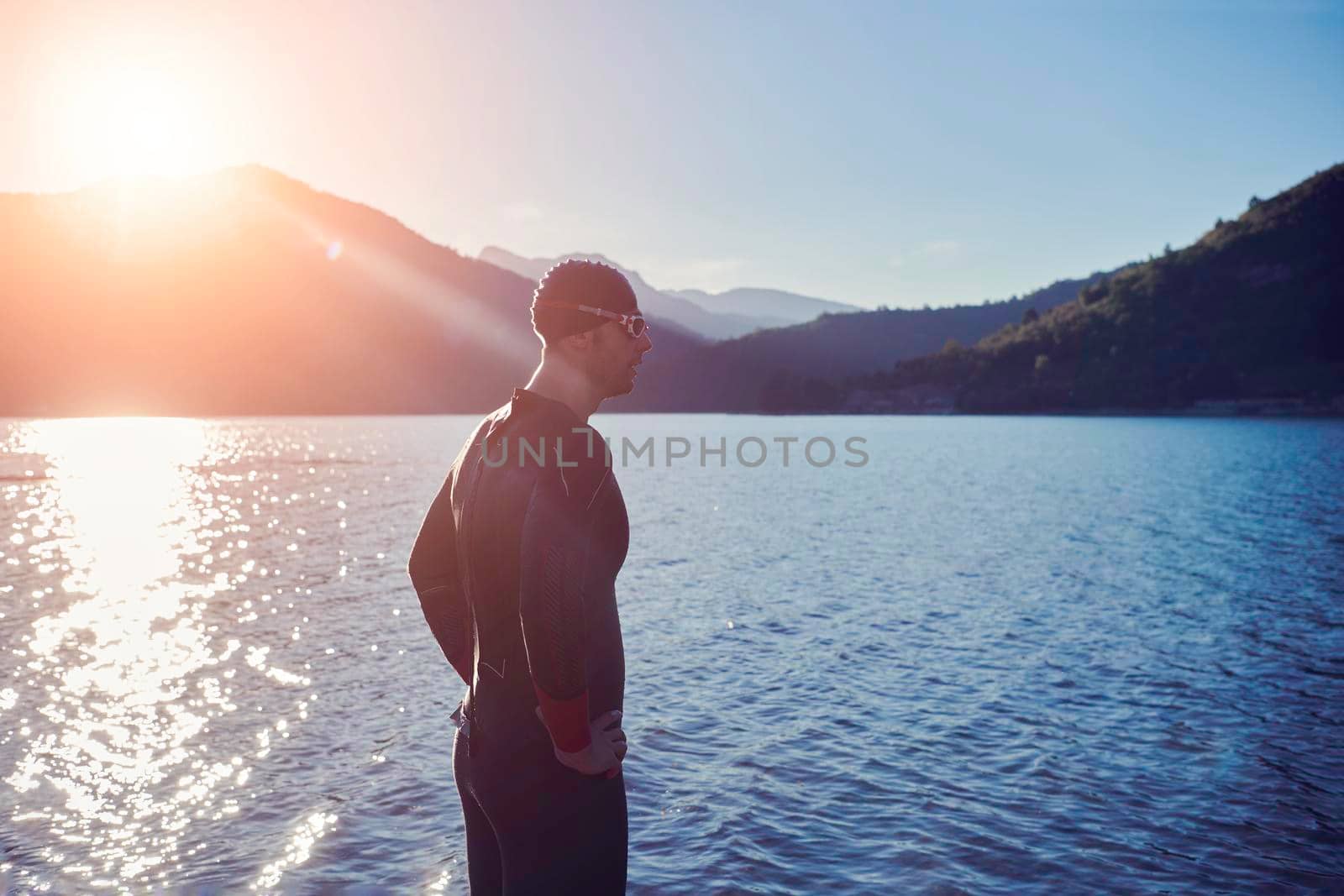 triathlon athlete start swimming training splashing water while running and jumping