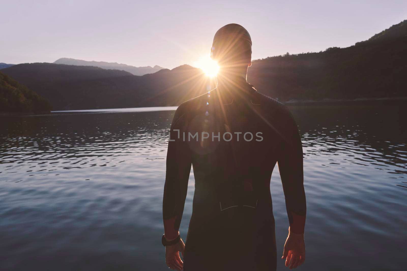 triathlon athlete start swimming training splashing water while running and jumping