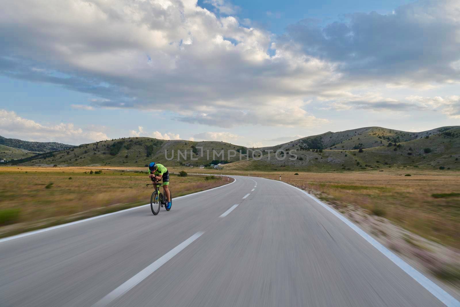 triathlon athlete riding bike by dotshock