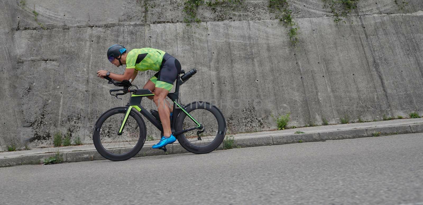 triathlon athlete riding racing bike on morning training urban enviroment