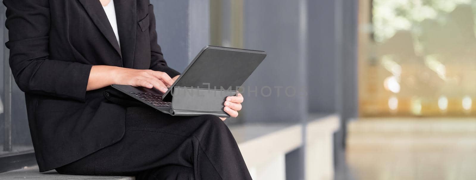 crop shot of business woman using digitall tablet with keyboard by nateemee