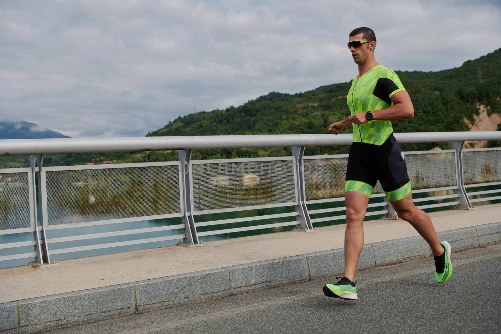 triathlon athlete running on street urban enviroment morning training workout