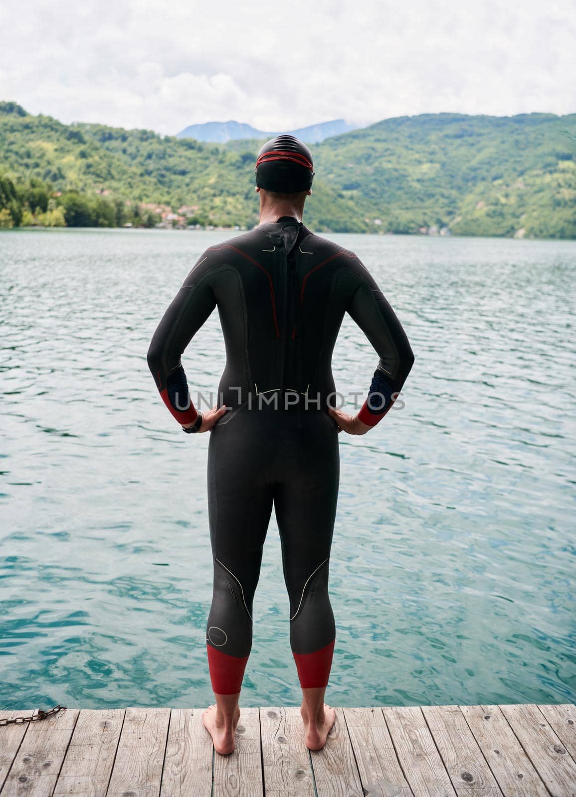 authentic triathlete swimmer portrait wearing wetsuit on morning  training