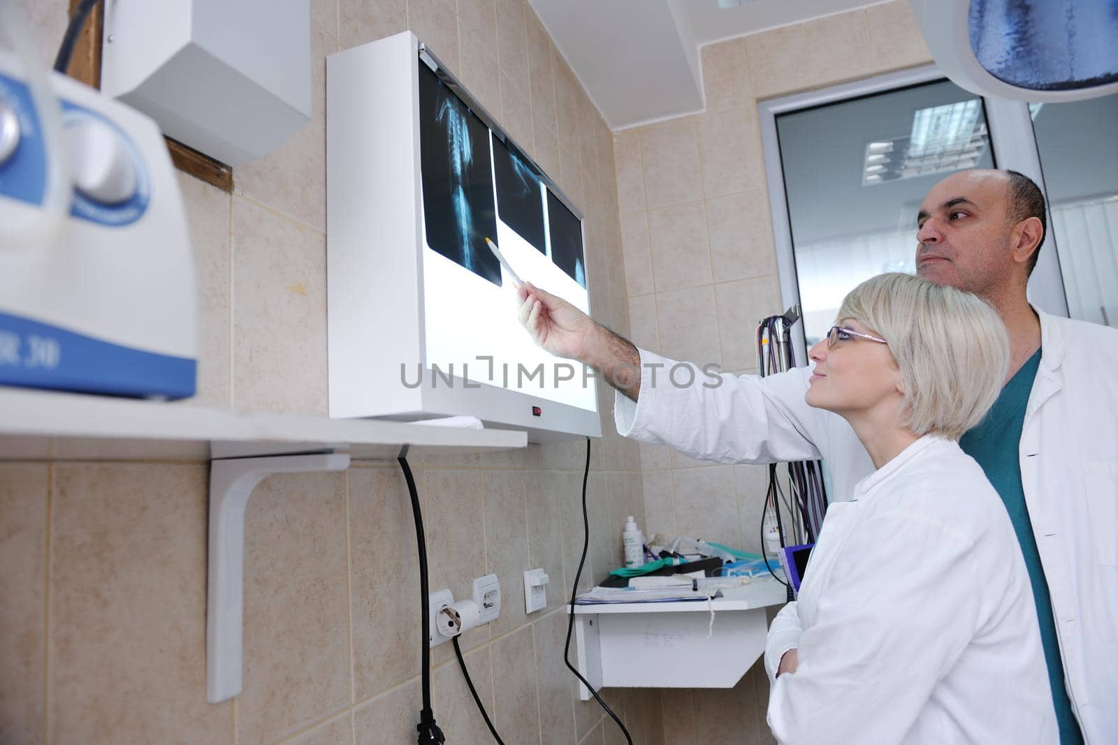 portrait of a veterinarian and assistant in a small animal clinic at work