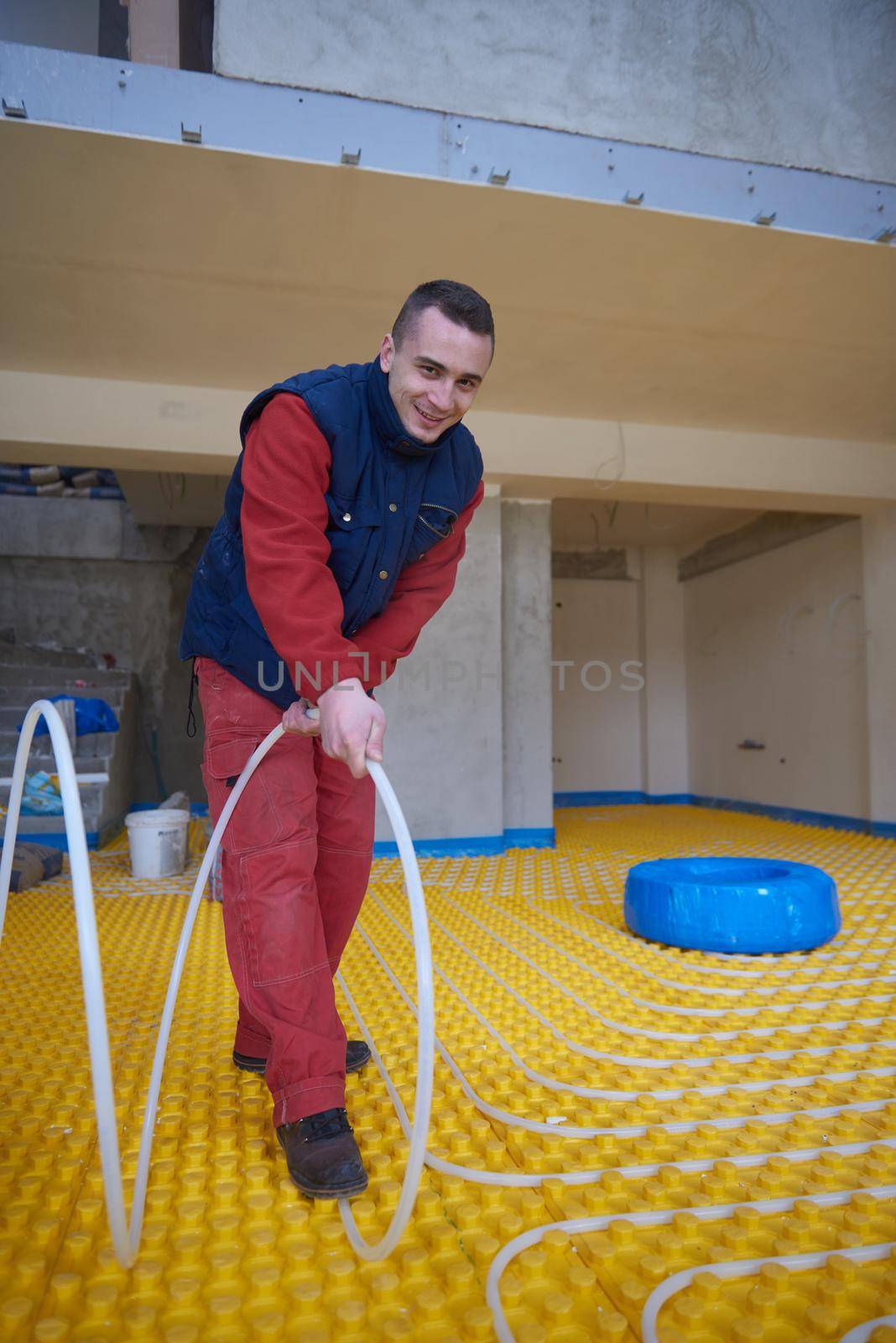 grouo of workera installing underfloor heating and colling in modern home