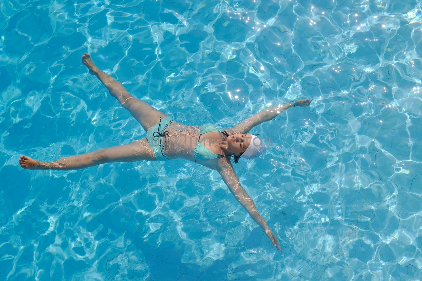 happy young woman relax at swimming pool at vacation travel resort 