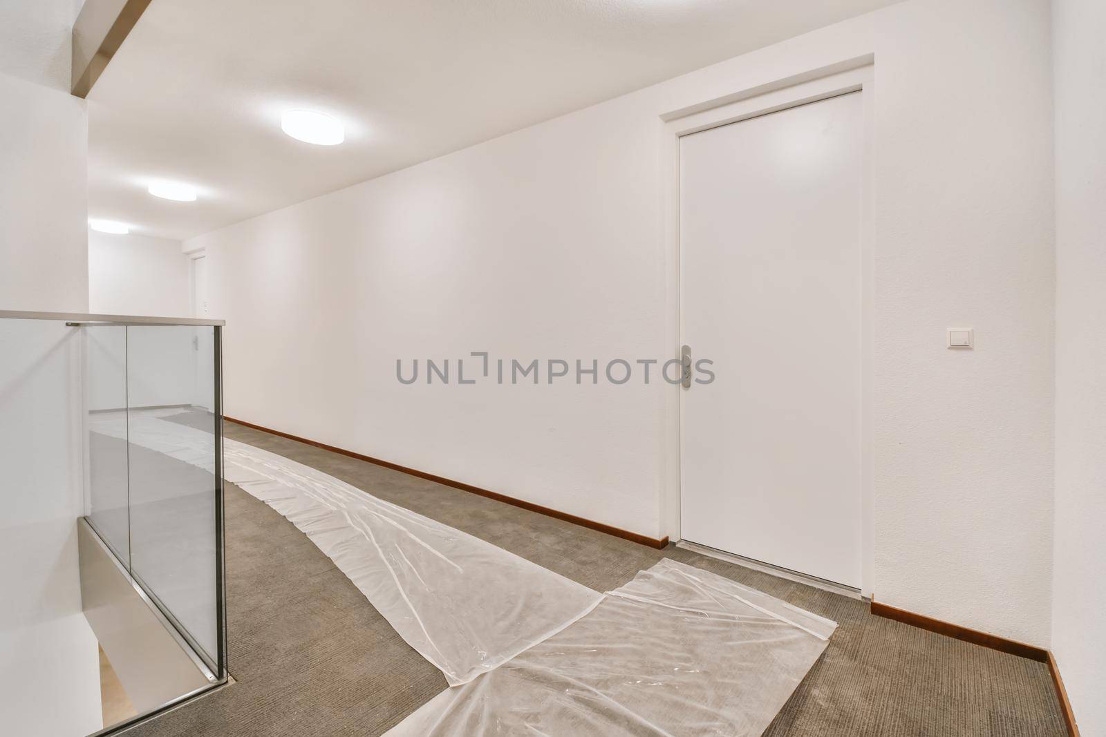 Wide corridor with white walls by casamedia