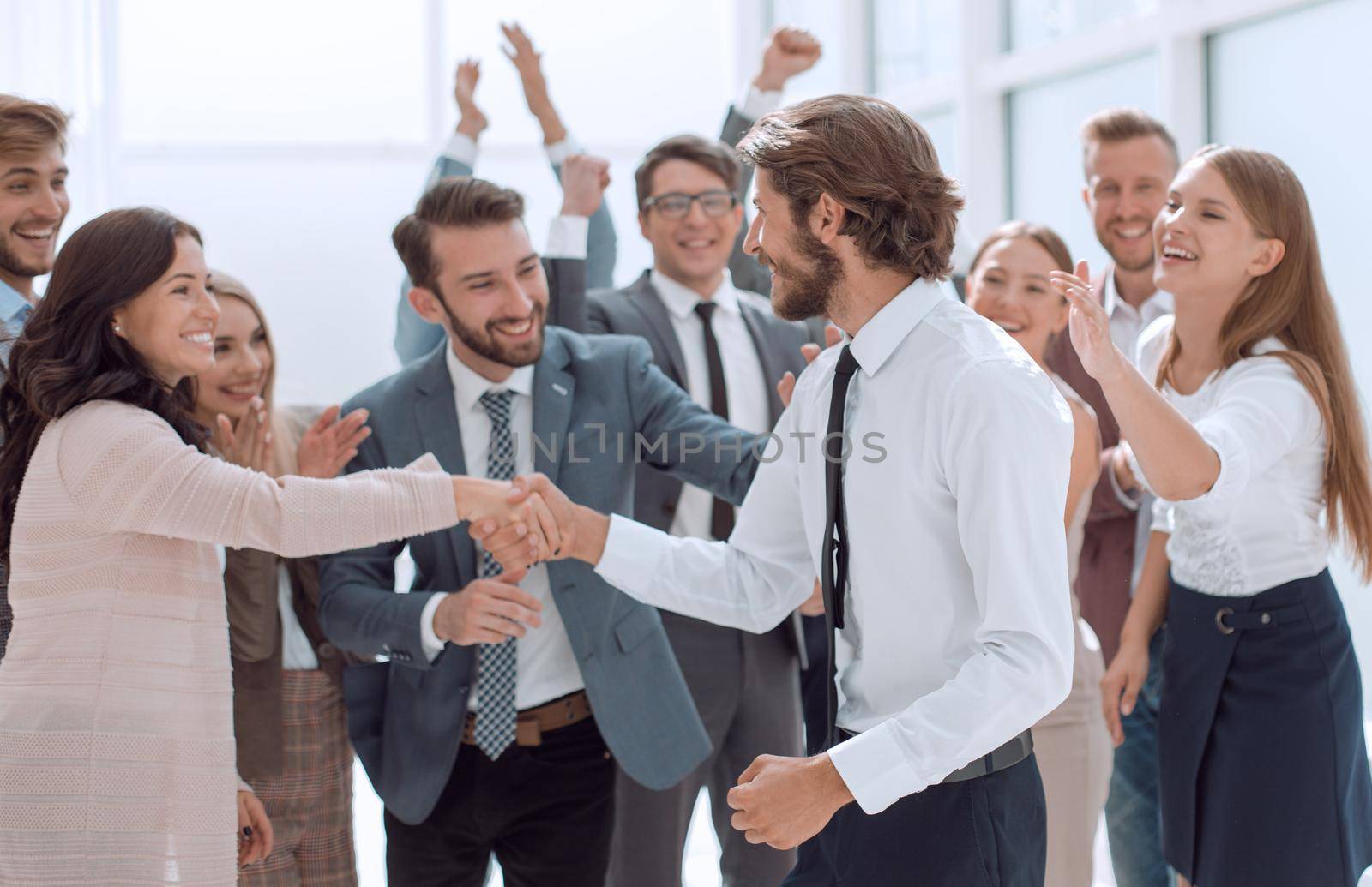 happy group of employees congratulating their leader . success concept