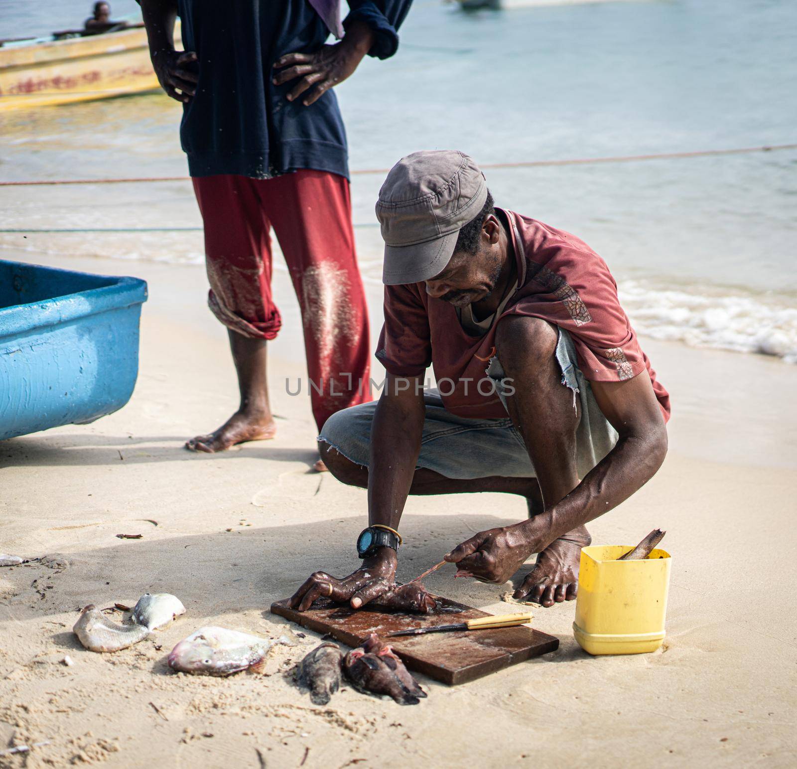 Candid black fisherman on the coast ocean