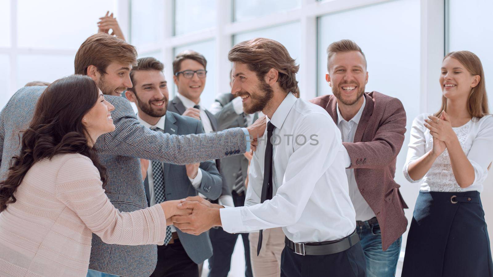 business team congratulating their leader on the victory . success concept