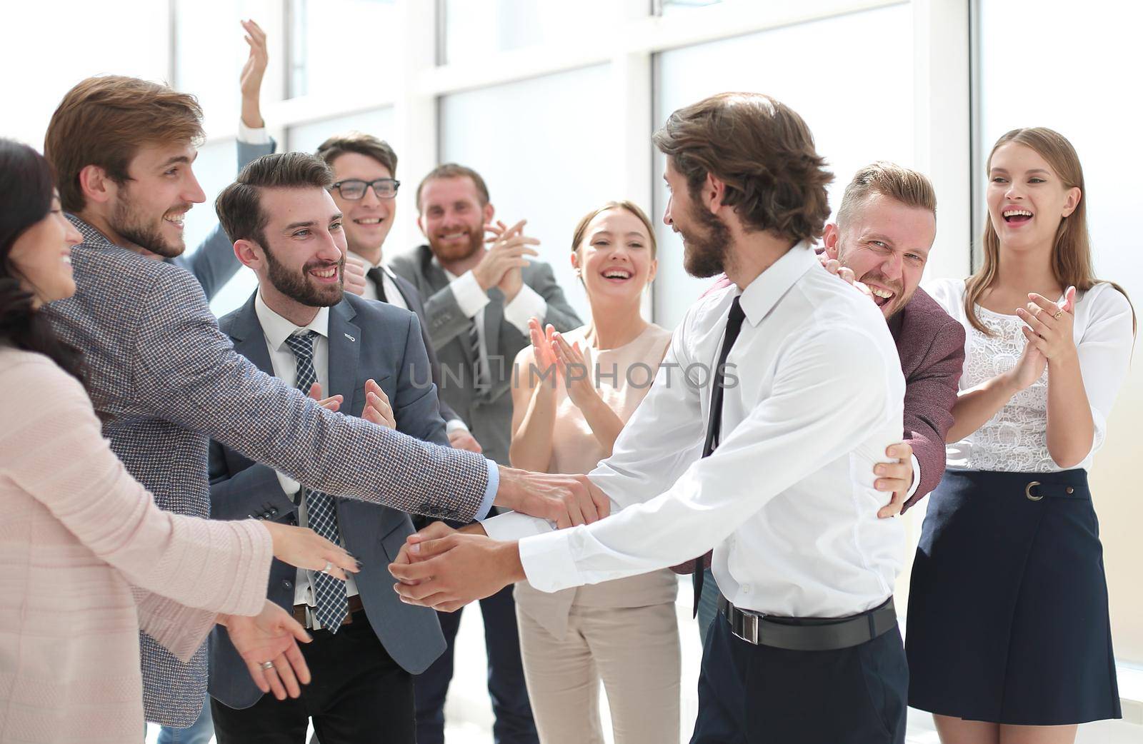 business team congratulating their leader on the victory by asdf