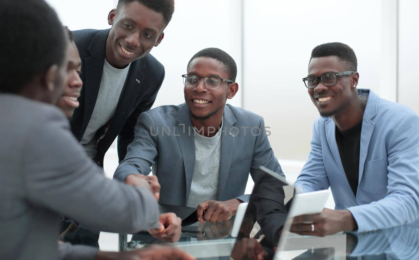 group of employees looking at the screen of a digital tablet. by asdf