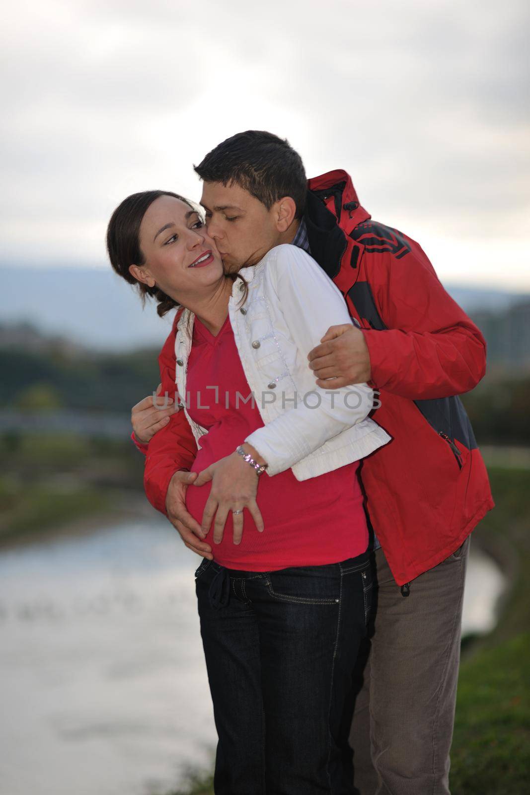 happy couple outdoor,  beautiful pregnant woman with her husband