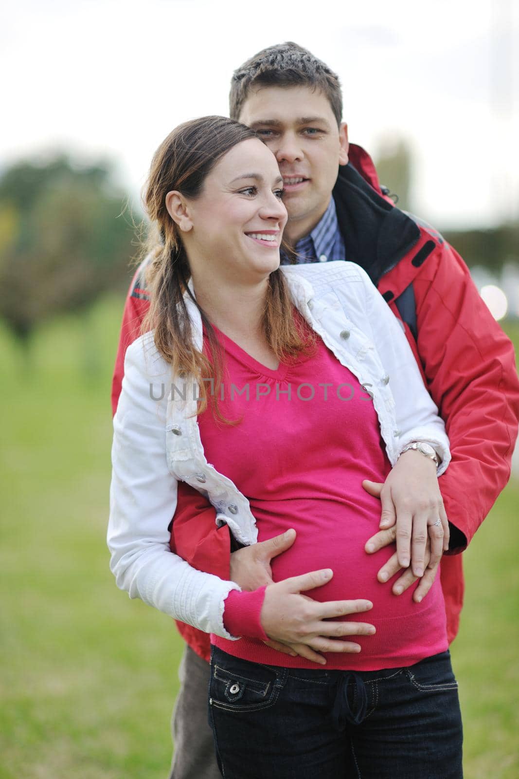 happy couple outdoor,  beautiful pregnant woman with her husband