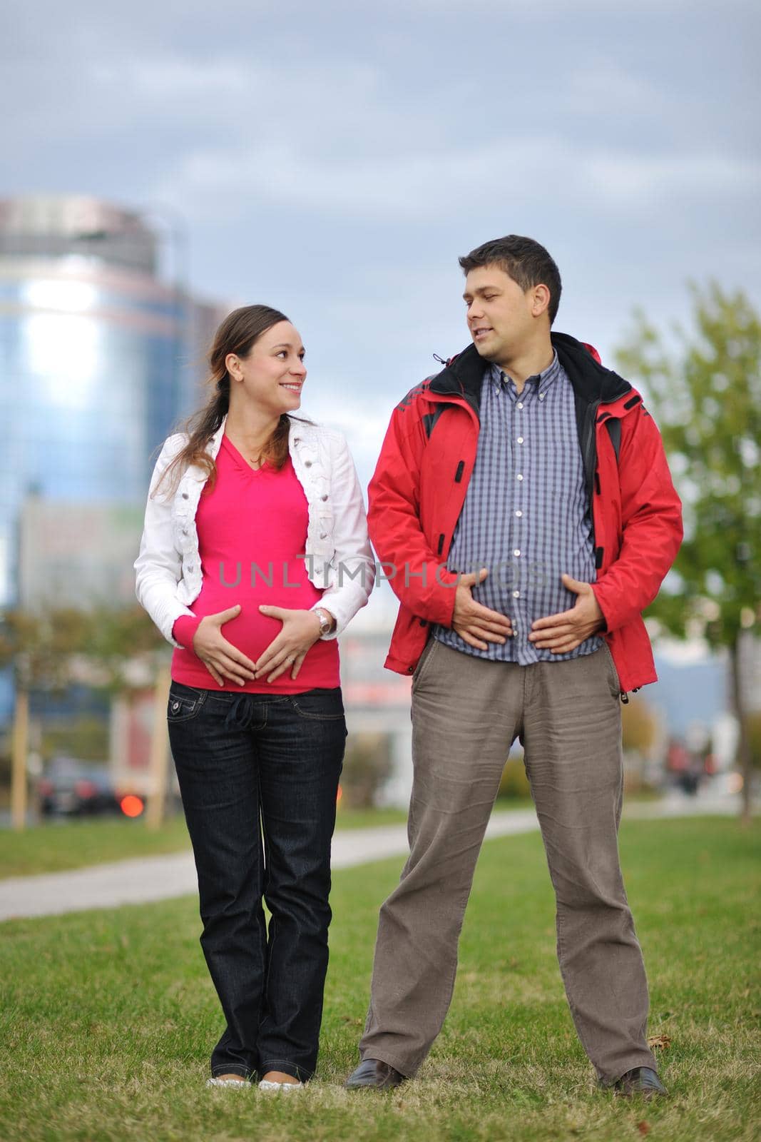 happy couple outdoor,  beautiful pregnant woman with her husband