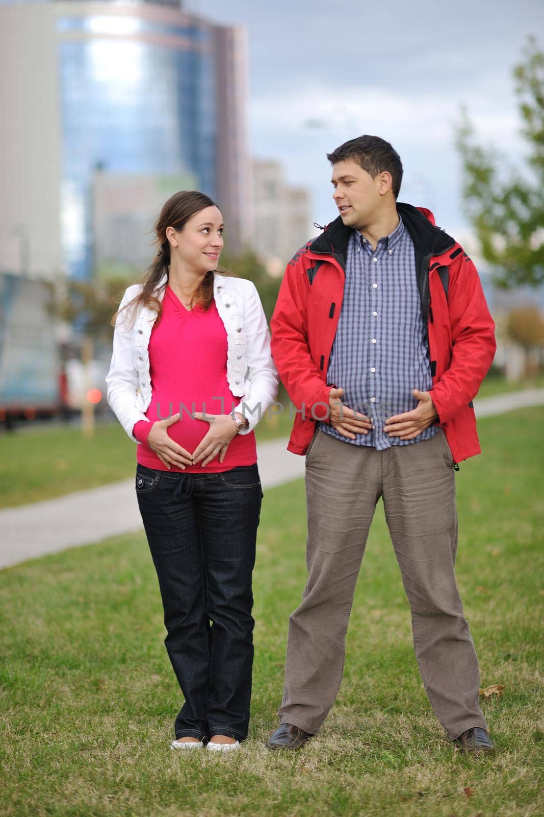 happy couple outdoor,  beautiful pregnant woman with her husband