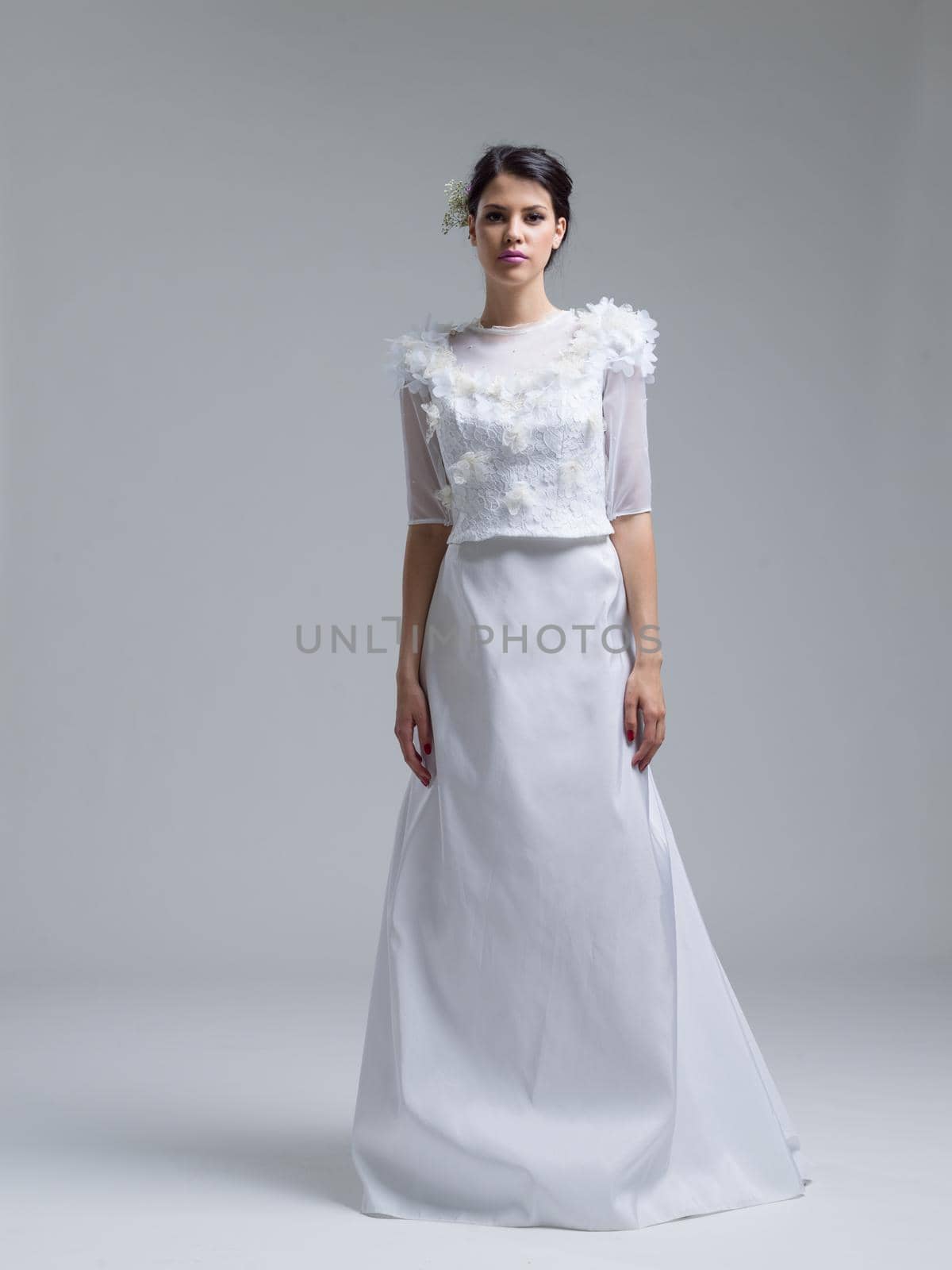 Portrait of beautiful young women in wedding dress isolated on a white background