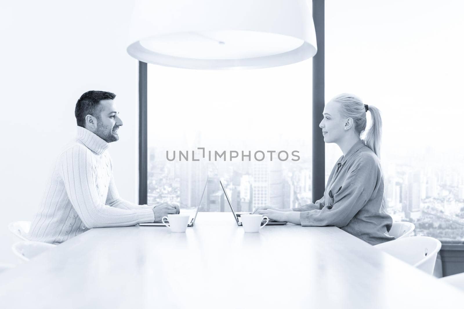 Group of a young business people discussing business plan at modern startup office building