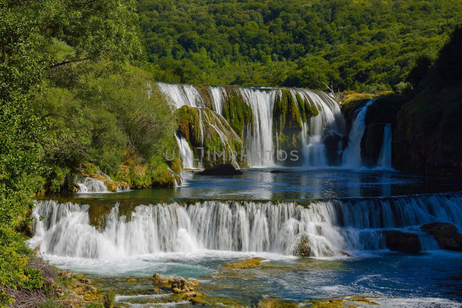 waterfall on wild river with fresh drinking water in summer