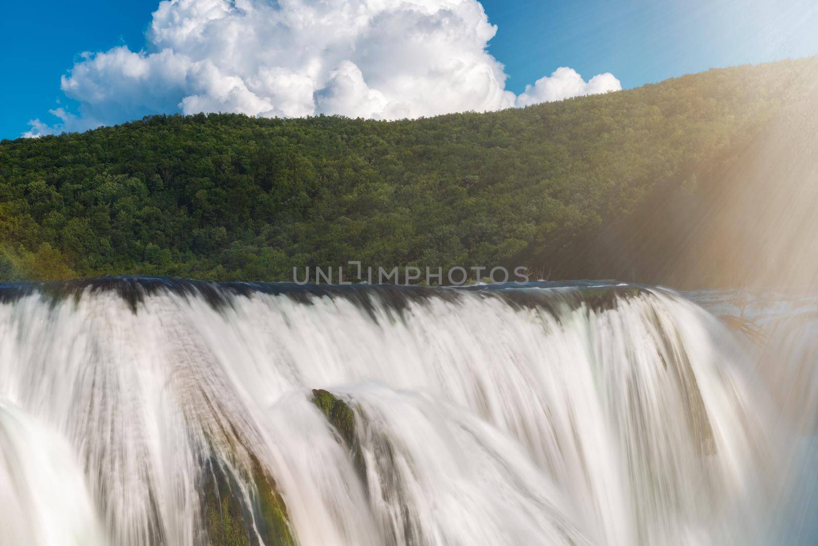 waterfall in beautiful nature with crystal clear water on wild river una in bosnia and herzegovina at sunny summer day